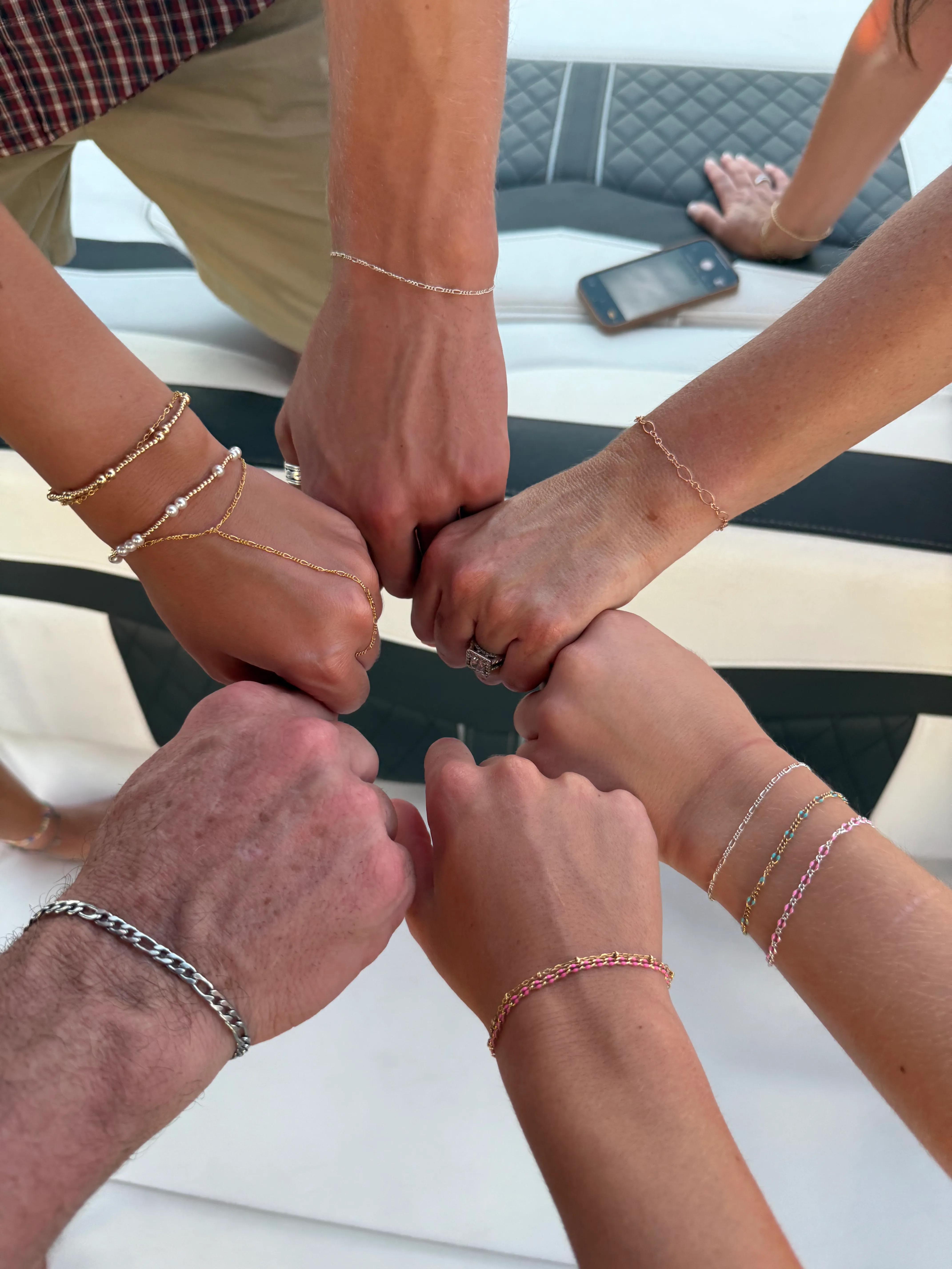 Friends showing their matching permanent jewelry
